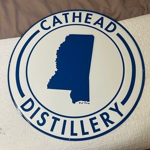 Cathead Mississippi vodka distillery tin sign